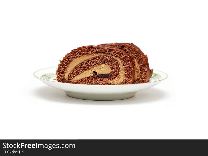 Two pieces of chocolate cake lying on china saucer