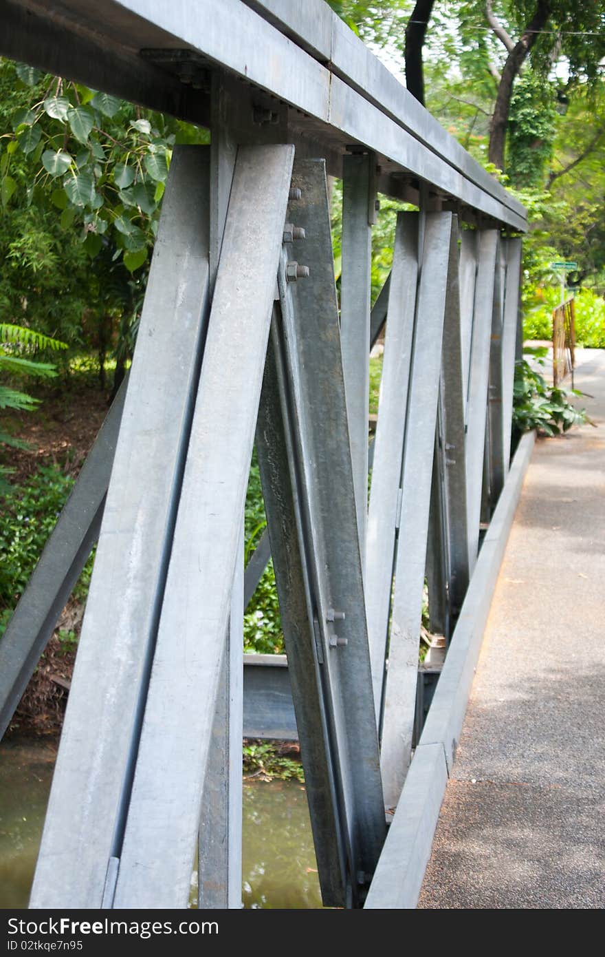 Bridge iron over water in the park, bridge in the park. Bridge iron over water in the park, bridge in the park