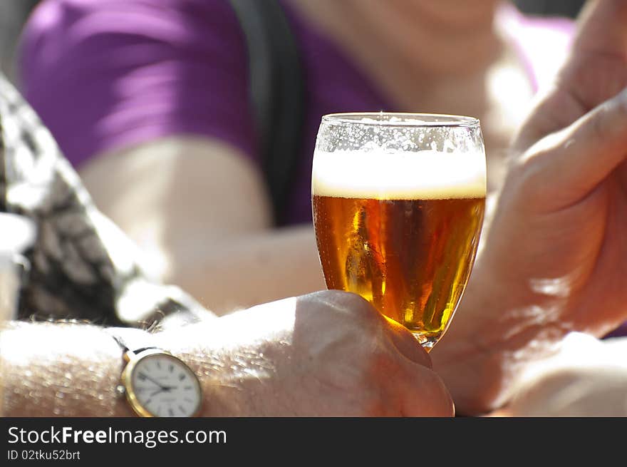 Man holding a glass of cold beer. Man holding a glass of cold beer