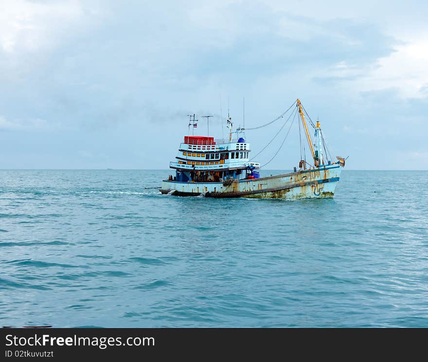 Old fish boat made of wood in the sea. Old fish boat made of wood in the sea