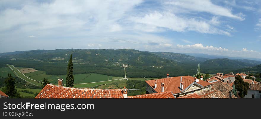 Panoramic landscape consisting of mountains, forests and sky