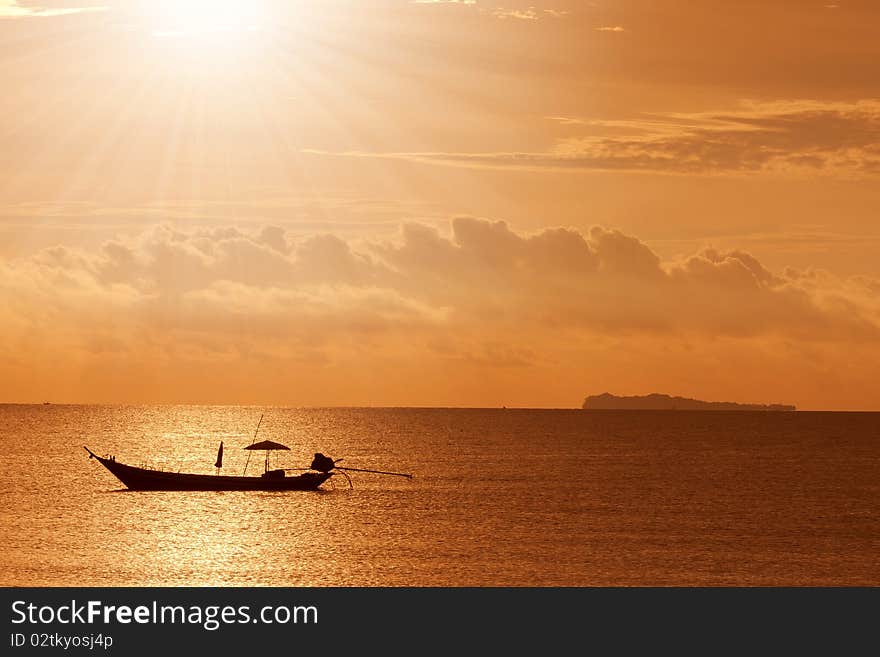 A boat to the sunset at sea