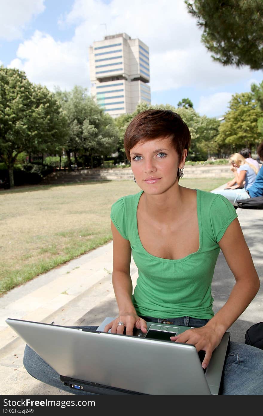 Student with laptop computer in college park. Student with laptop computer in college park