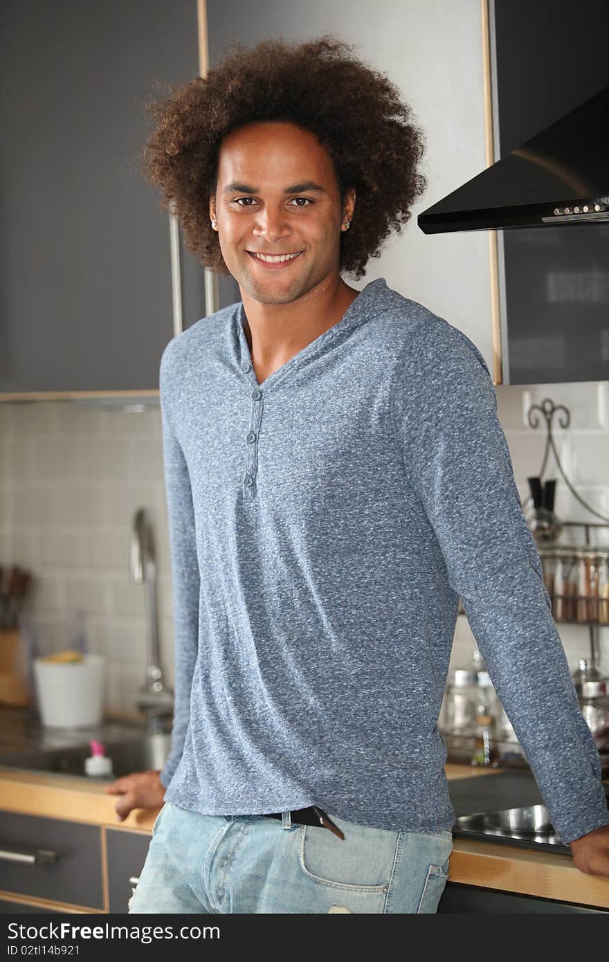 Young man standing in kitchen. Young man standing in kitchen