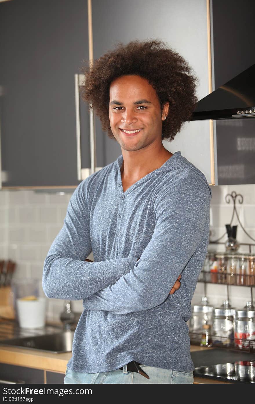 Young man standing in kitchen. Young man standing in kitchen