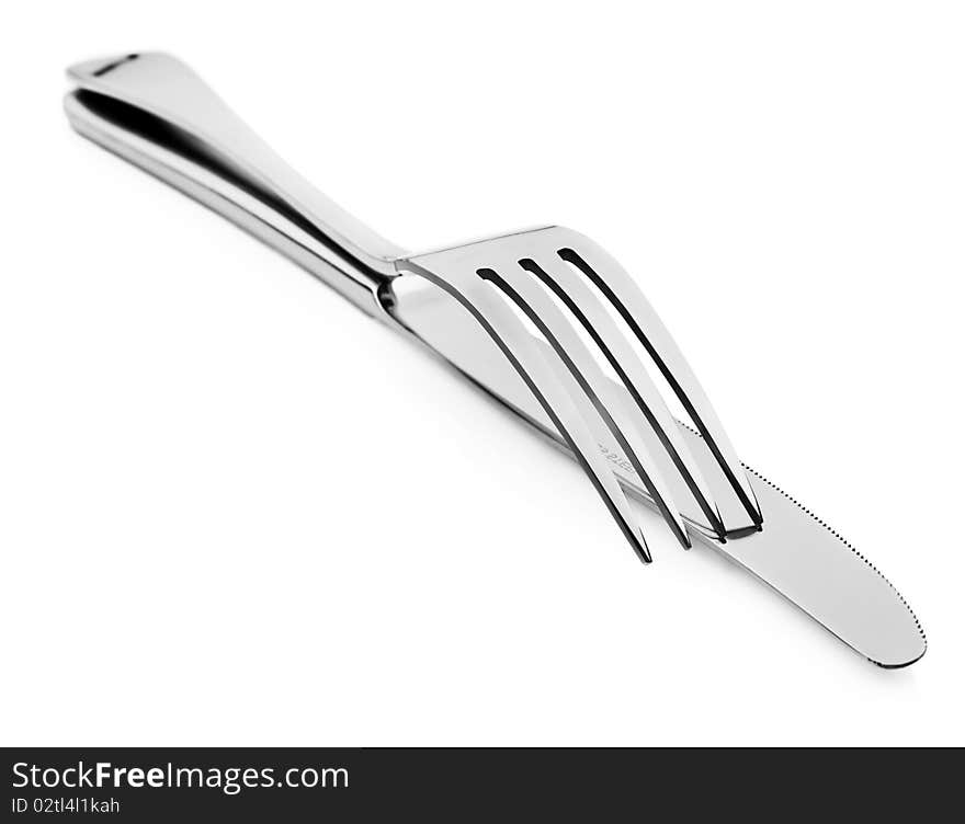 Close up abstract of a silver knife and fork on a white background with space for text