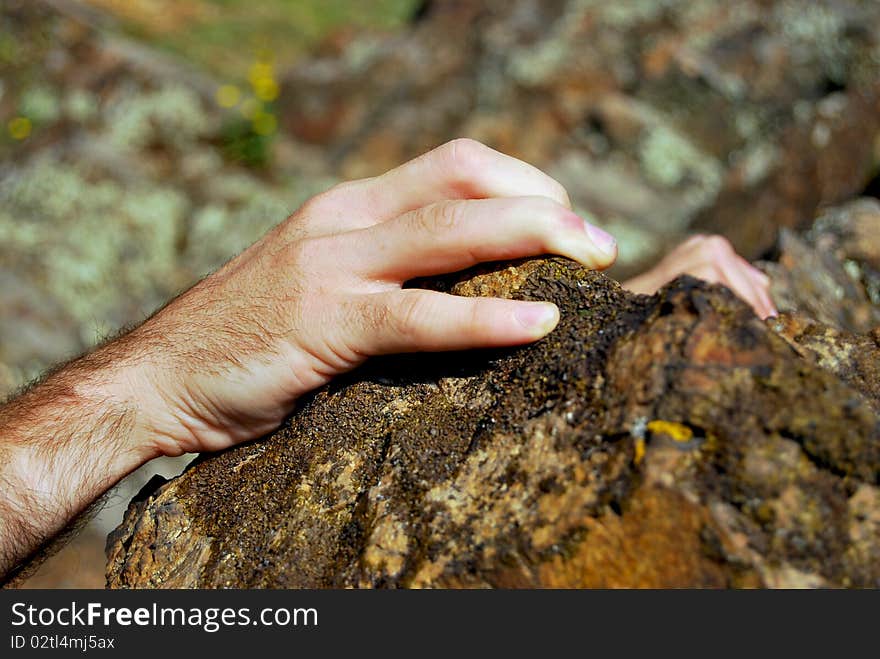 Climbers hands fixing on the edge of a cliff. Climbers hands fixing on the edge of a cliff