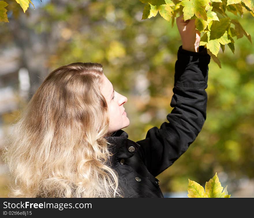 Portrait of Beautiful romantic blonde girl in the autumn park