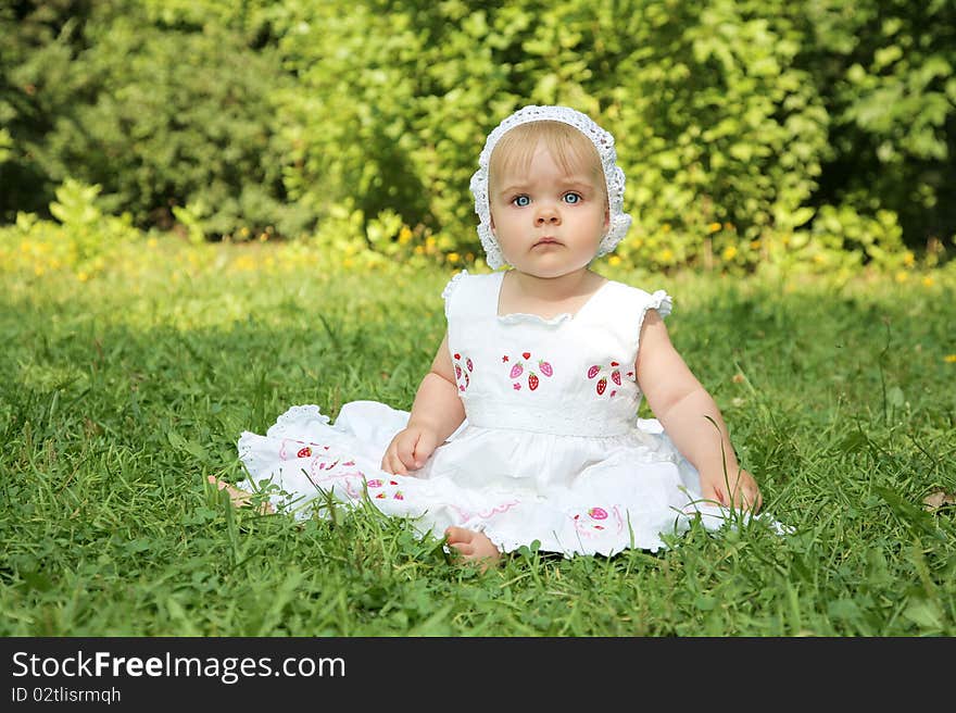 Portrait of cute little girl with blue eyes in white dress outdoor shot. Portrait of cute little girl with blue eyes in white dress outdoor shot