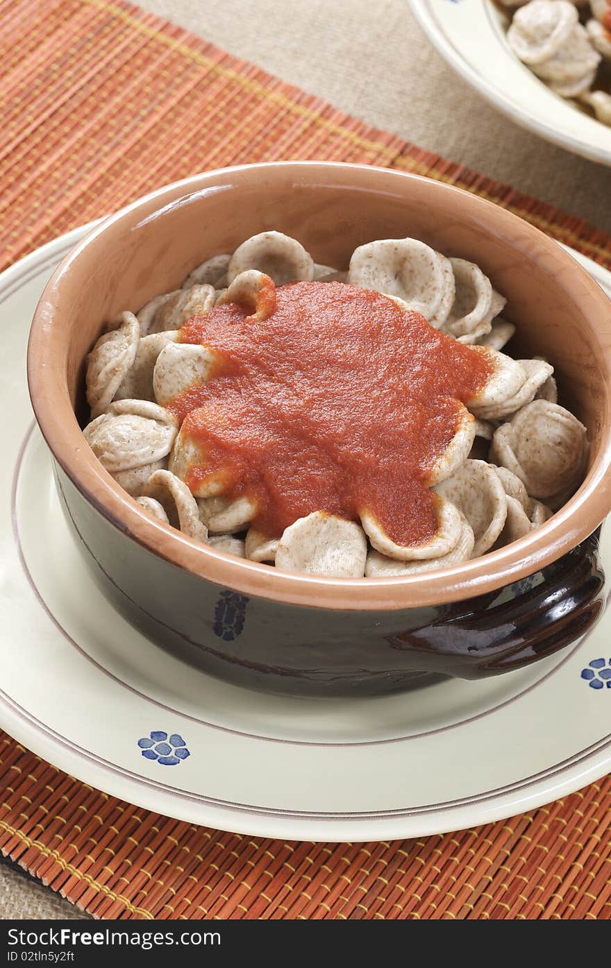 South italian traditional recipe "orecchiette" pasta with tomato sauce