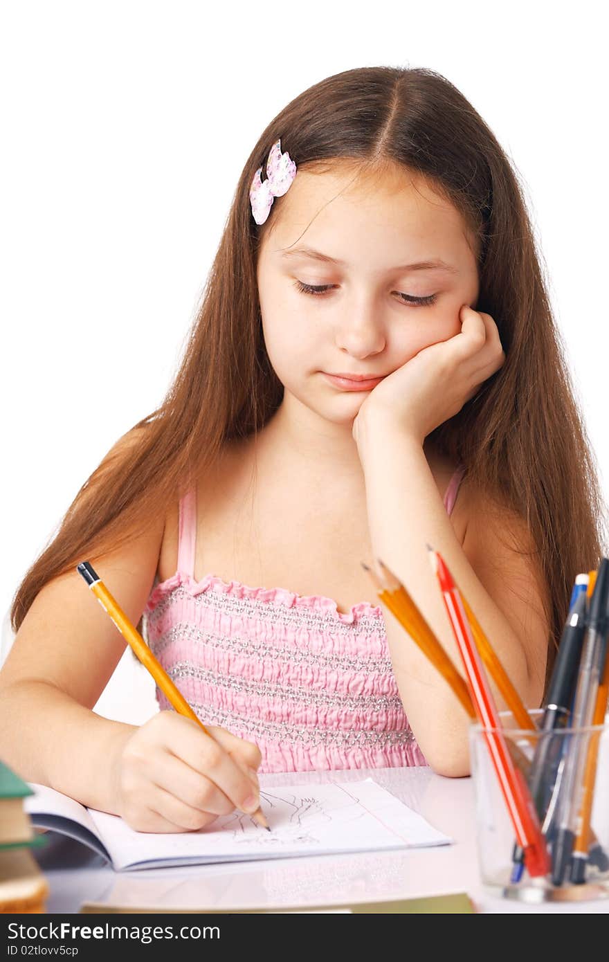 Cute little girl sketching something in the copybook. Cute little girl sketching something in the copybook