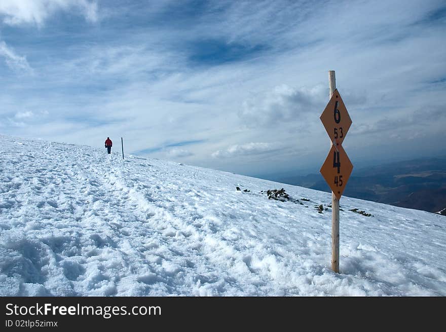 Marked tourist path in the winter mountains