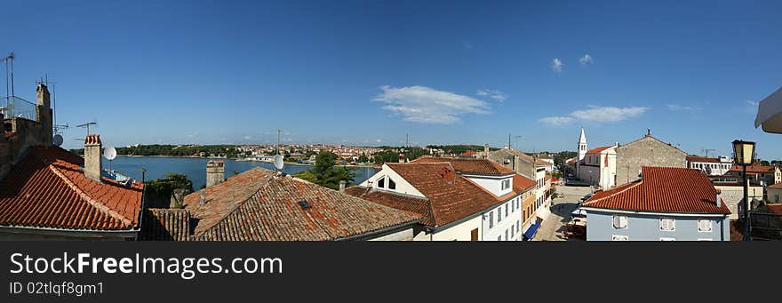 Panoramic landscape with the sky, the sea and rooftops, Porec, Croatia