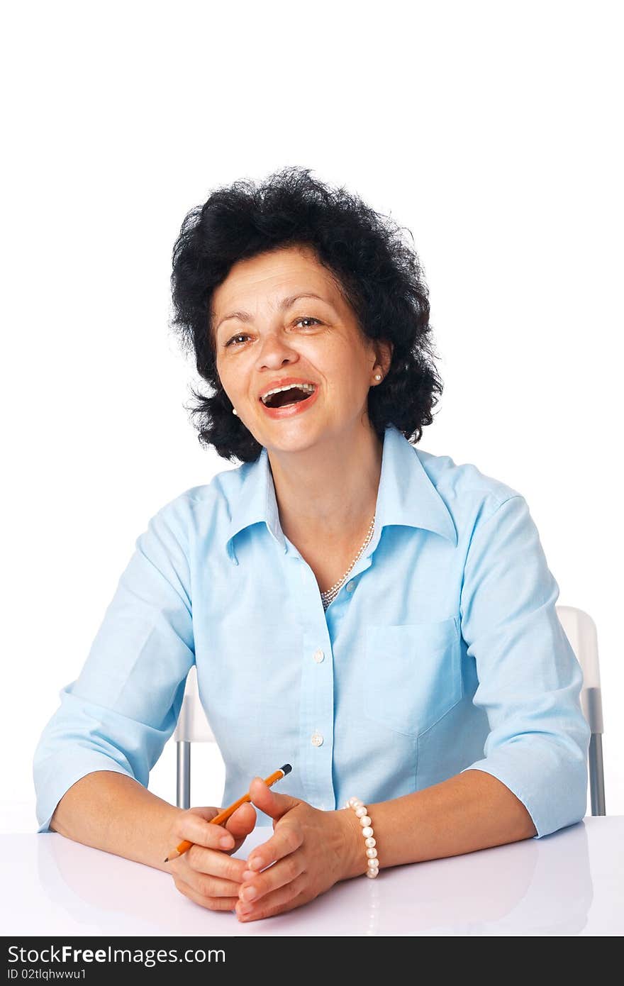 Elder woman smiling and sitting at the table. Elder woman smiling and sitting at the table.