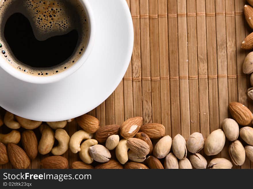 Cup of coffee with nuts. Focus on coffee foam