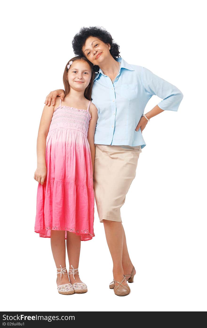 A full length portrait of grandmother embracing her grand daughter. A full length portrait of grandmother embracing her grand daughter.