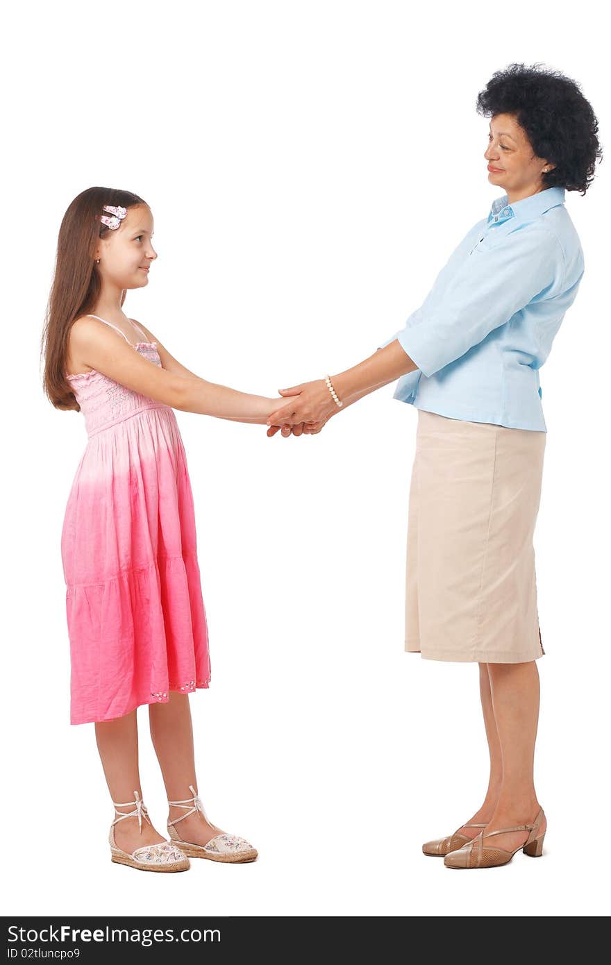 A full length portrait of grandmother holding hands with  her granddaughter. A full length portrait of grandmother holding hands with  her granddaughter.