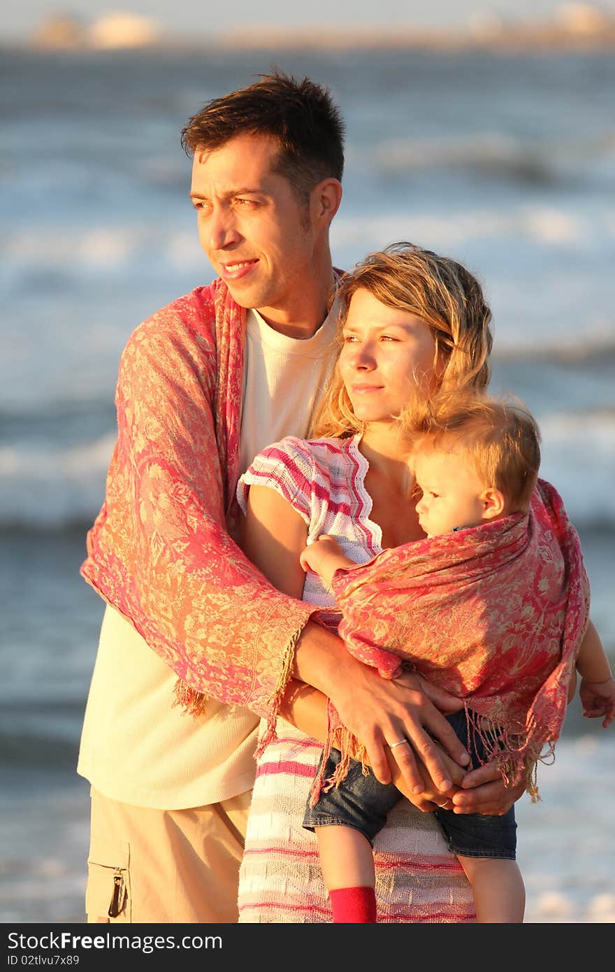 Young family looking at the sea