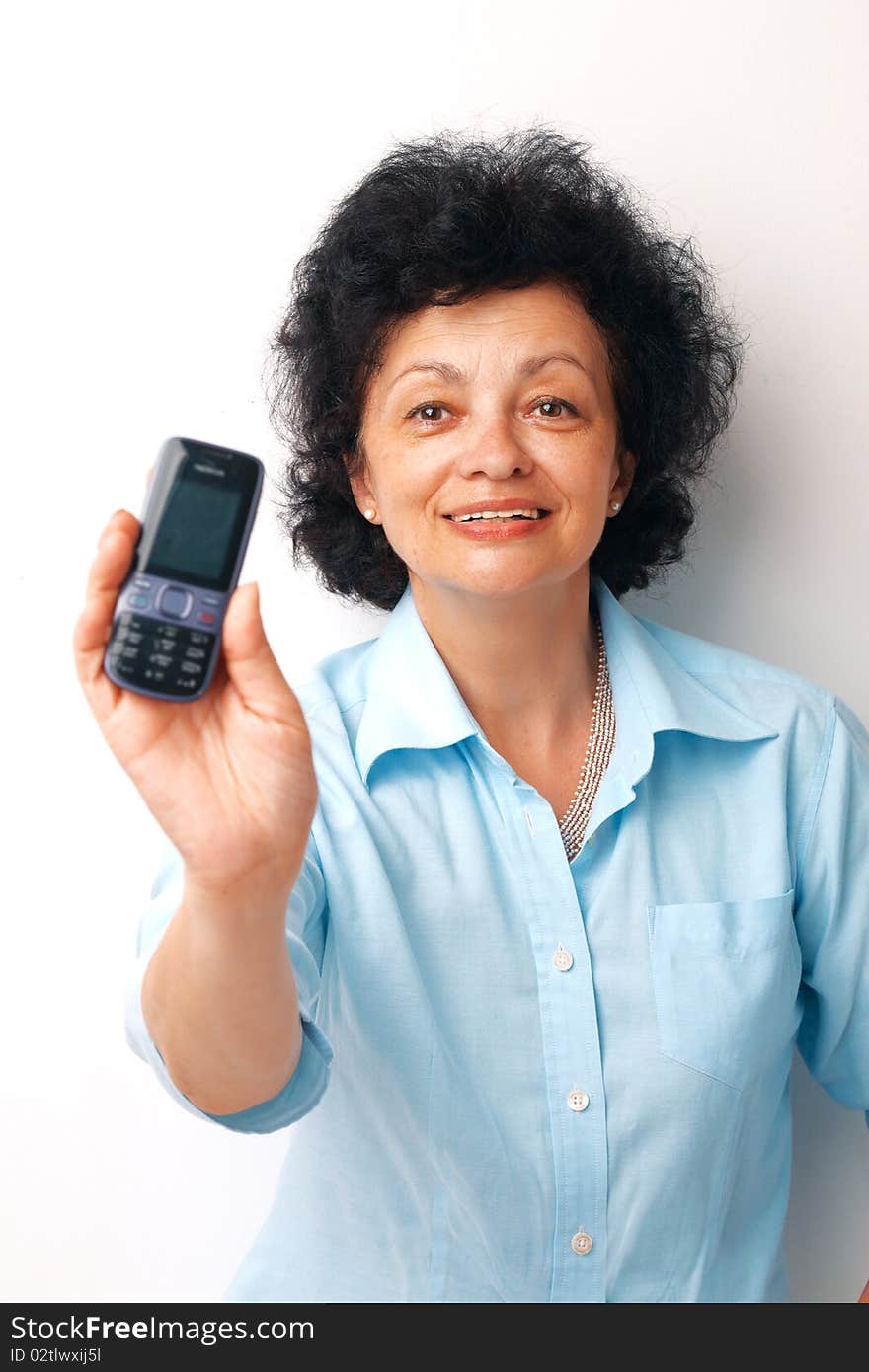 Elder smiling woman holding and showing her mobile. Elder smiling woman holding and showing her mobile.