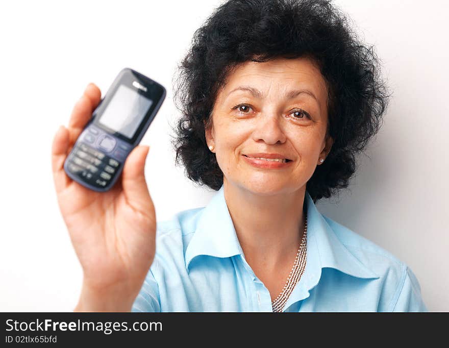 Close-up of an elder smiling woman holding and showing her mobile. Close-up of an elder smiling woman holding and showing her mobile.