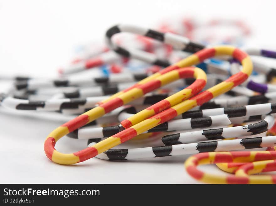 Colored paper clips office on a white background