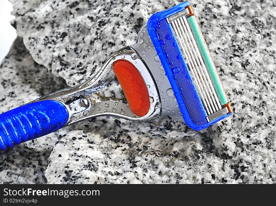 Razor on stone background in studio