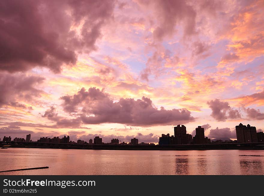 The beautiful sunset at the city near the river