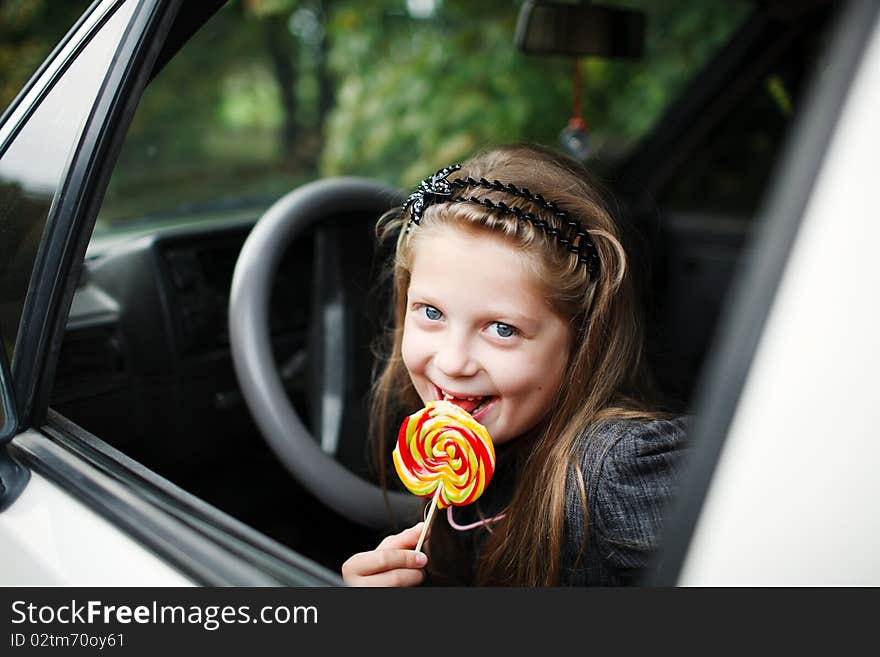 Llittle girl wit candy in his hand. Llittle girl wit candy in his hand