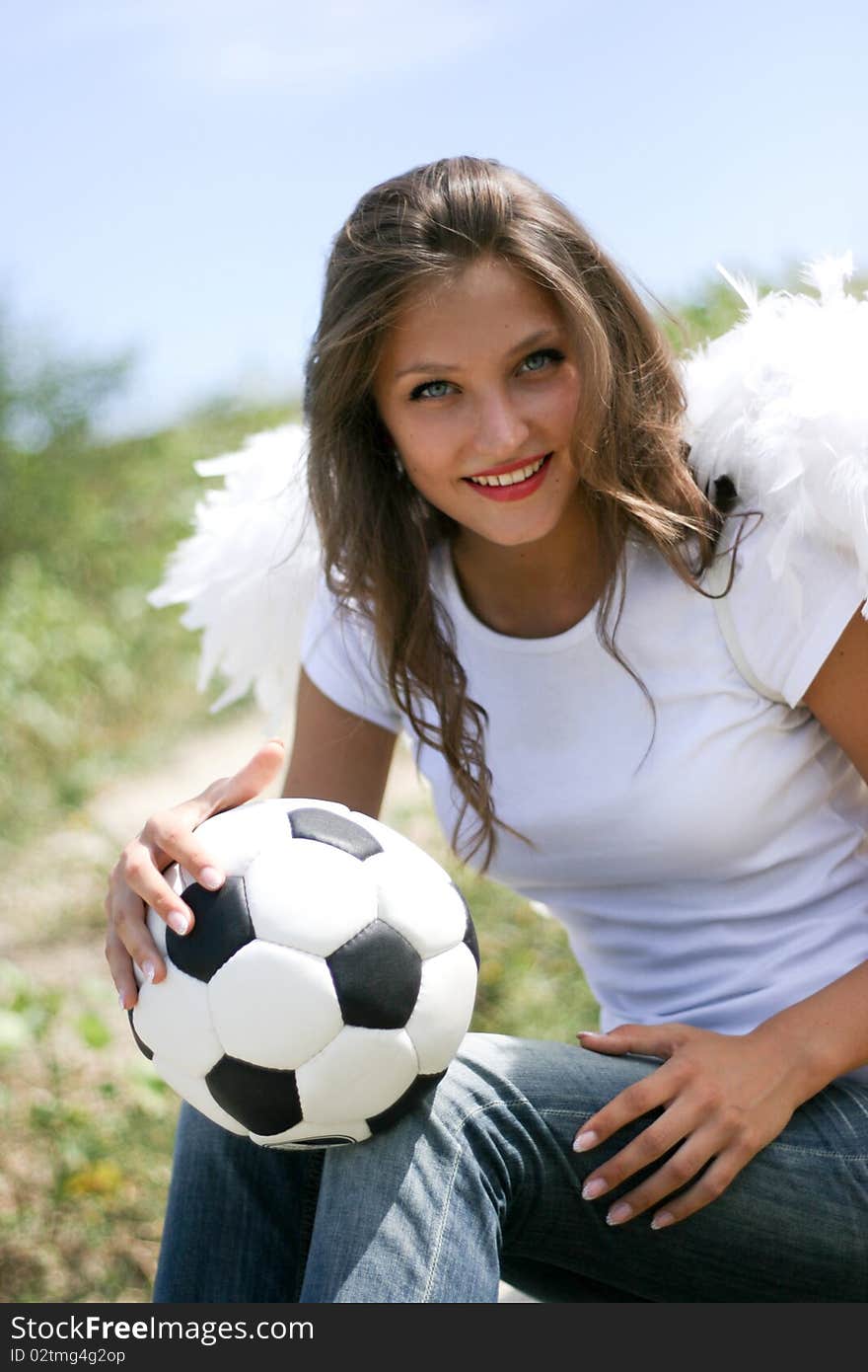 Pretty angel with soccer ball