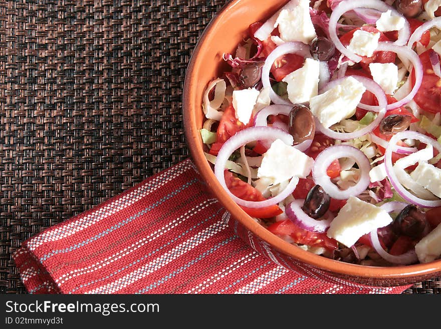 Greek salad in an earthenware bowl