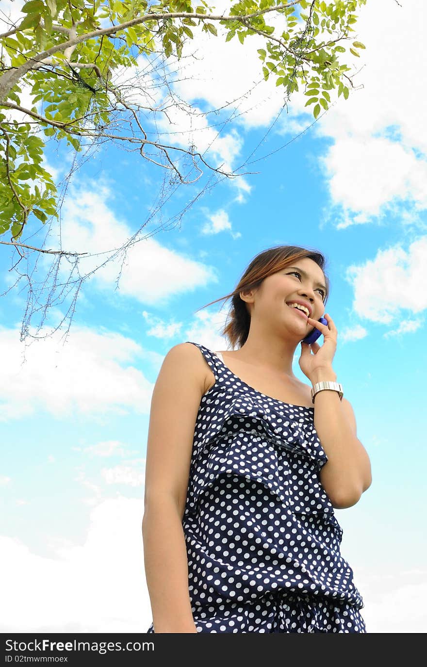 Asia woman is talking a telephone