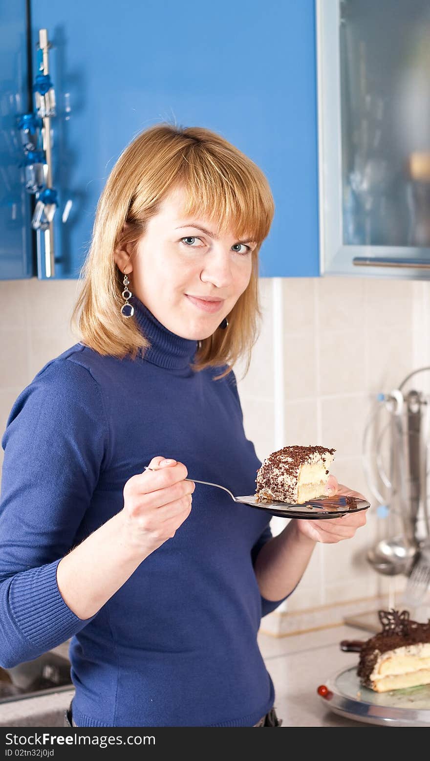 Young woman holding a slice of cake