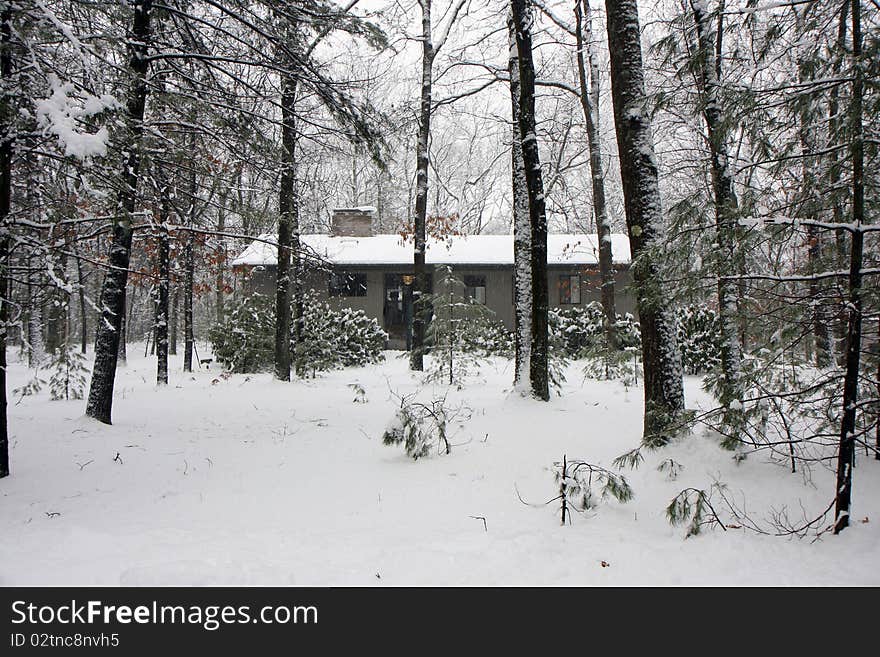 House in winter snow surrownded by forest trees. House in winter snow surrownded by forest trees