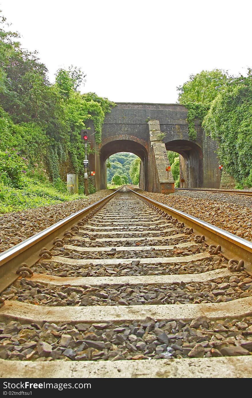 Low view of Rail Track going under Viaduct