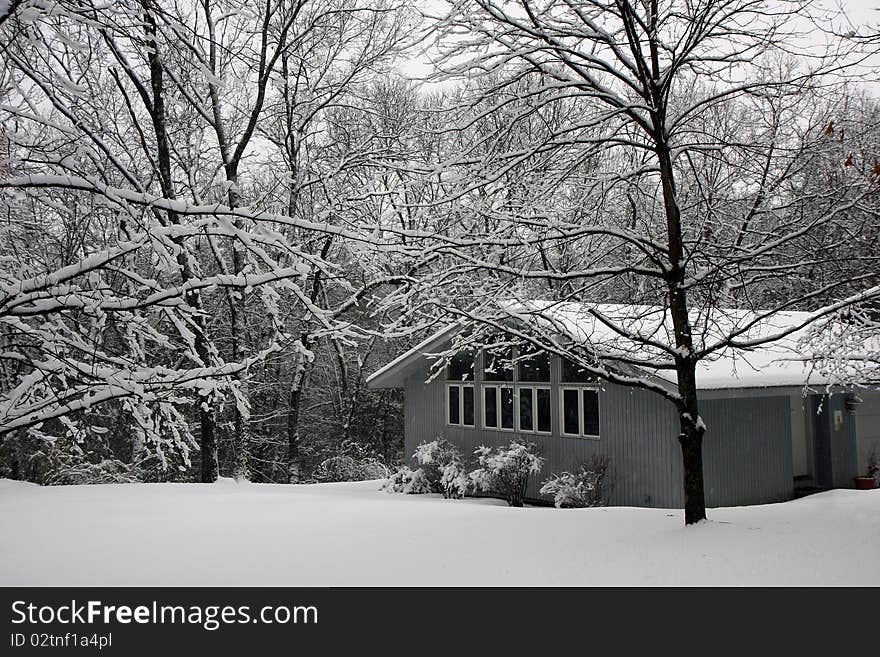 House in winter snow surrownded by forest trees. House in winter snow surrownded by forest trees