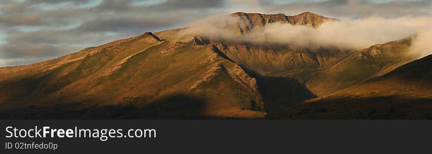 The morning sun illuminates mountain peaks in Hatcher Pass, Alaska. The morning sun illuminates mountain peaks in Hatcher Pass, Alaska.