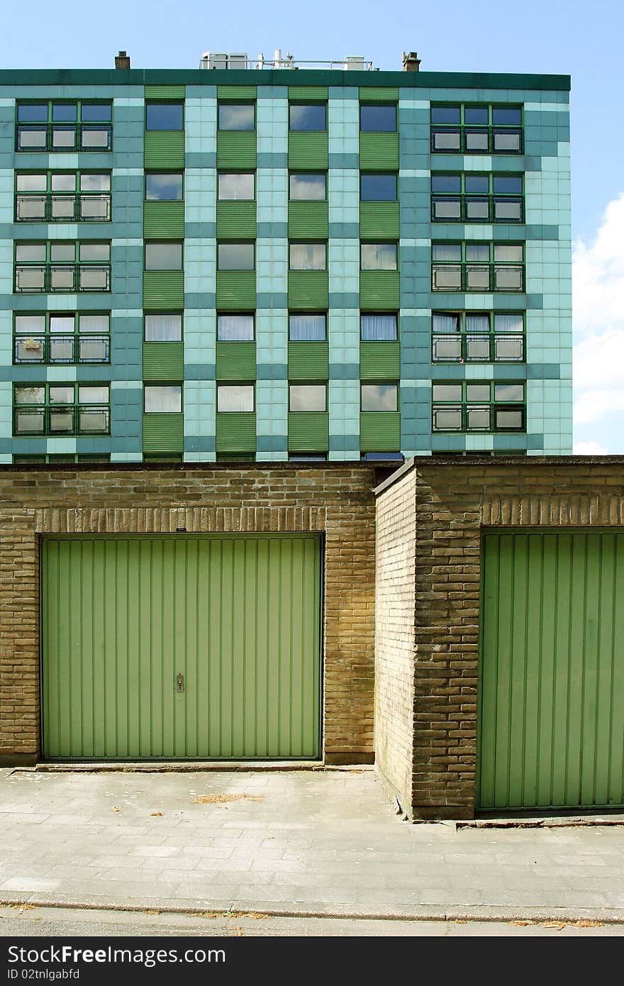 Apartment building and parking boxes with green details. Apartment building and parking boxes with green details