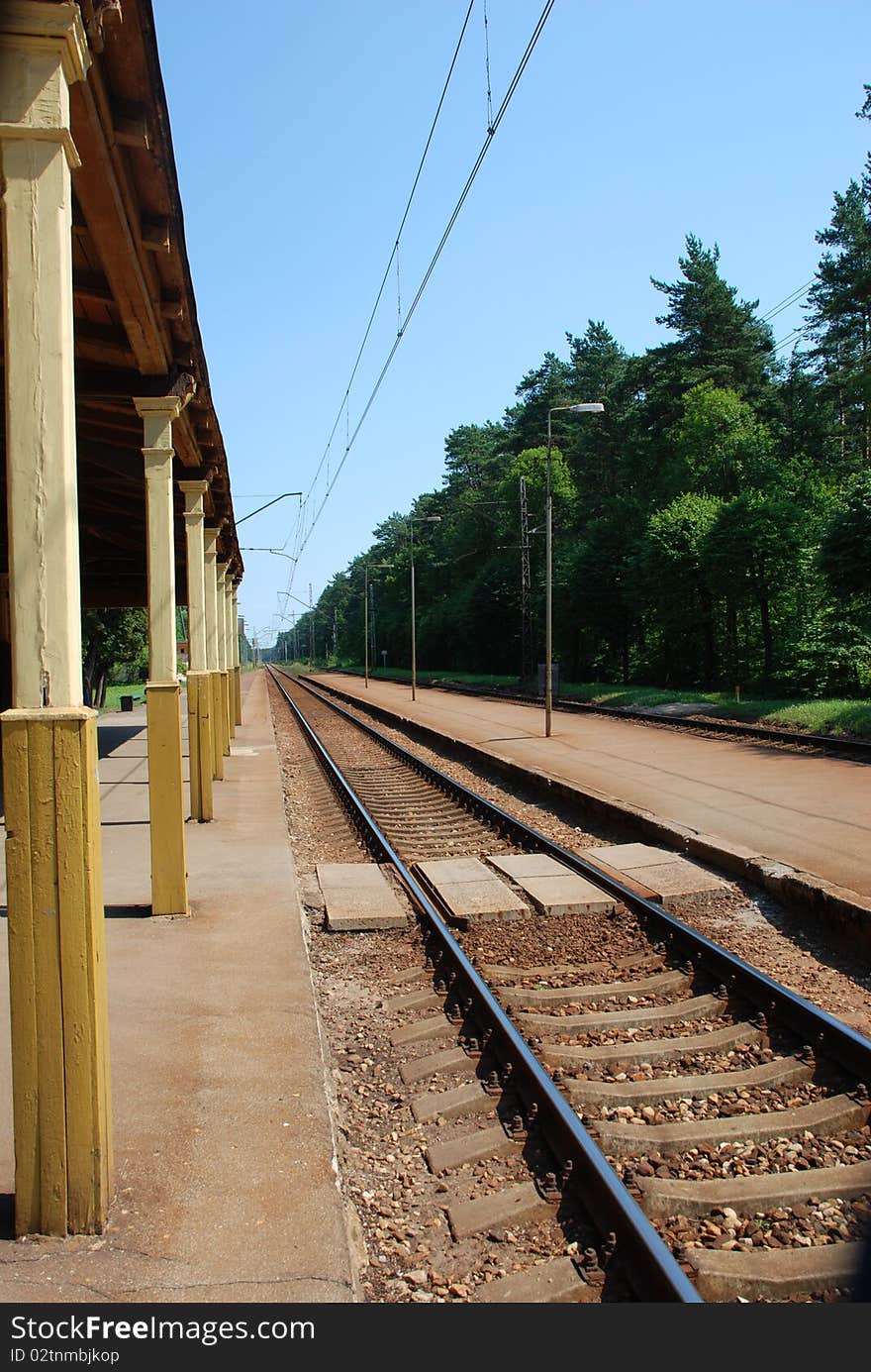 A view of a railway track with railroad station platform. A view of a railway track with railroad station platform