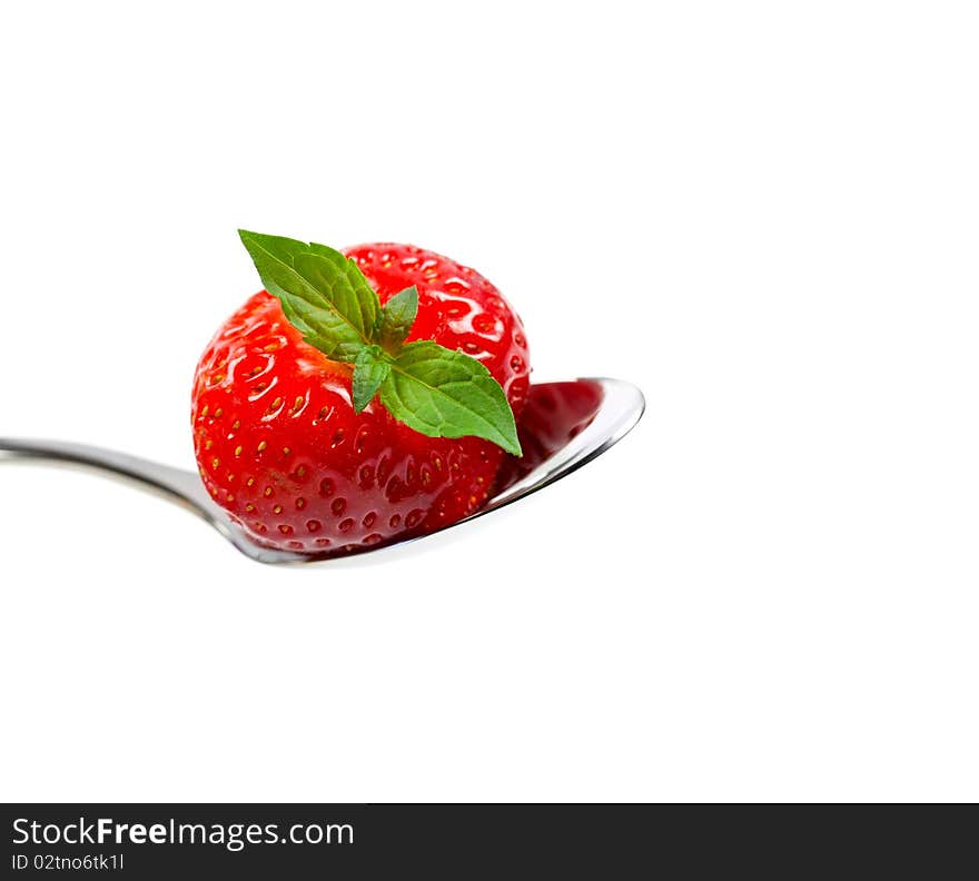 Strawberry on spoon isolated on white