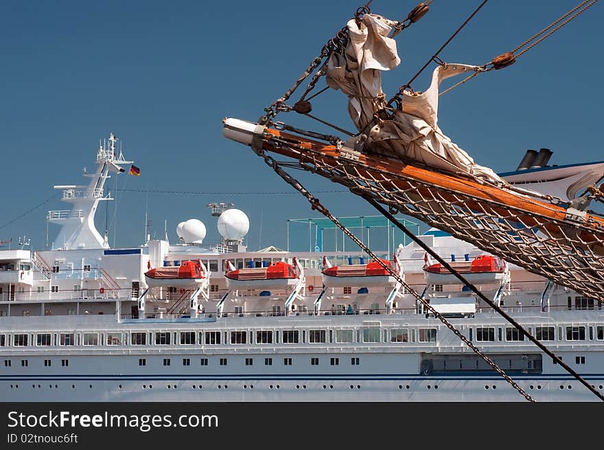 Cruise ship near the old sailboat