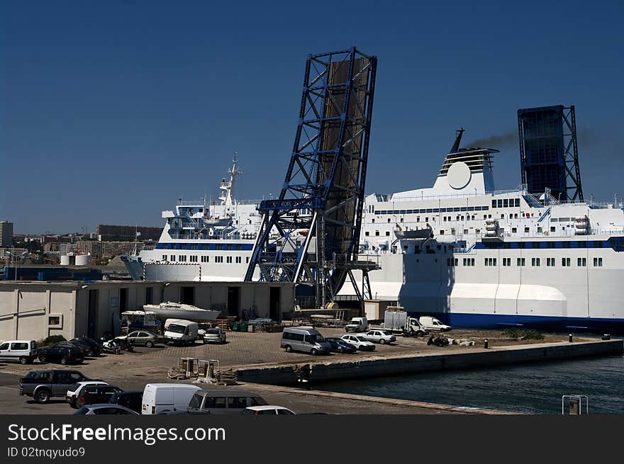 A passenger ferry in Marseille leaving the port and passing under an open drawbridge. A passenger ferry in Marseille leaving the port and passing under an open drawbridge