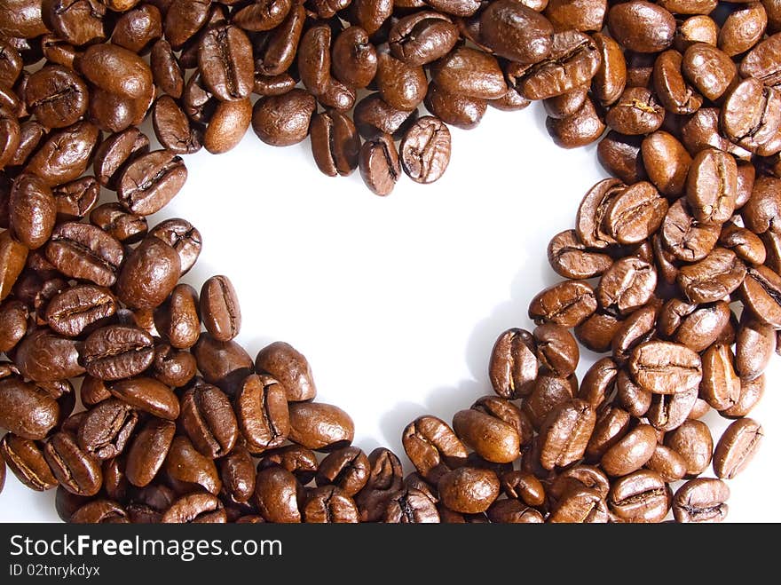 Heart of coffee grains is on the white background. Heart of coffee grains is on the white background