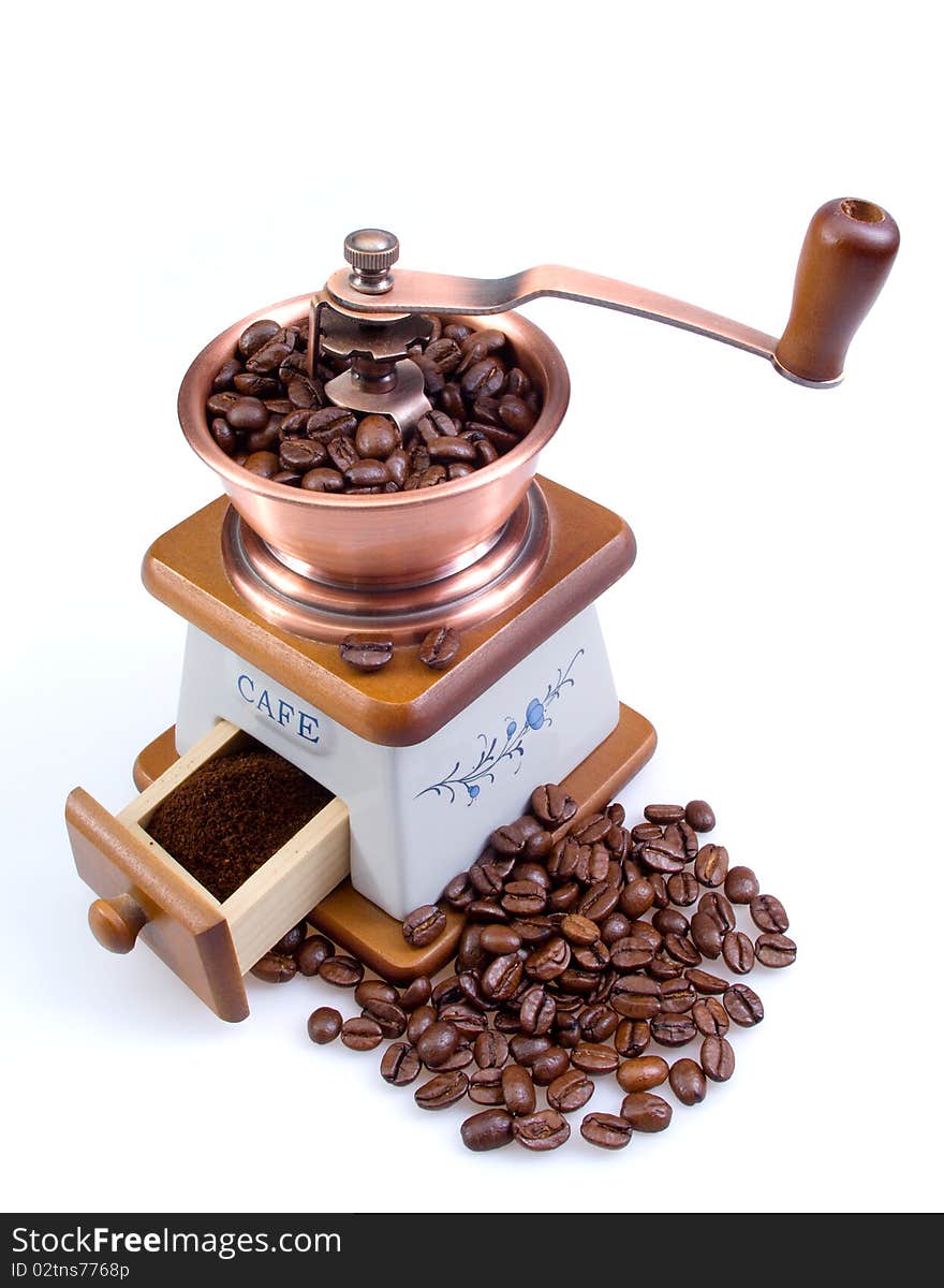 Old coffee grinder with coffee grains