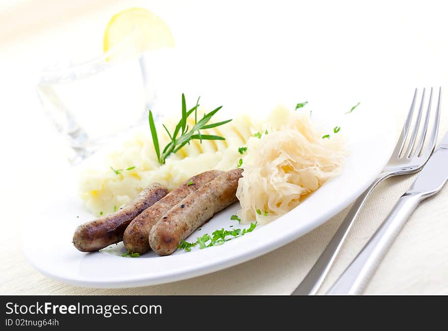 Fried sausage and sauerkraut on plate