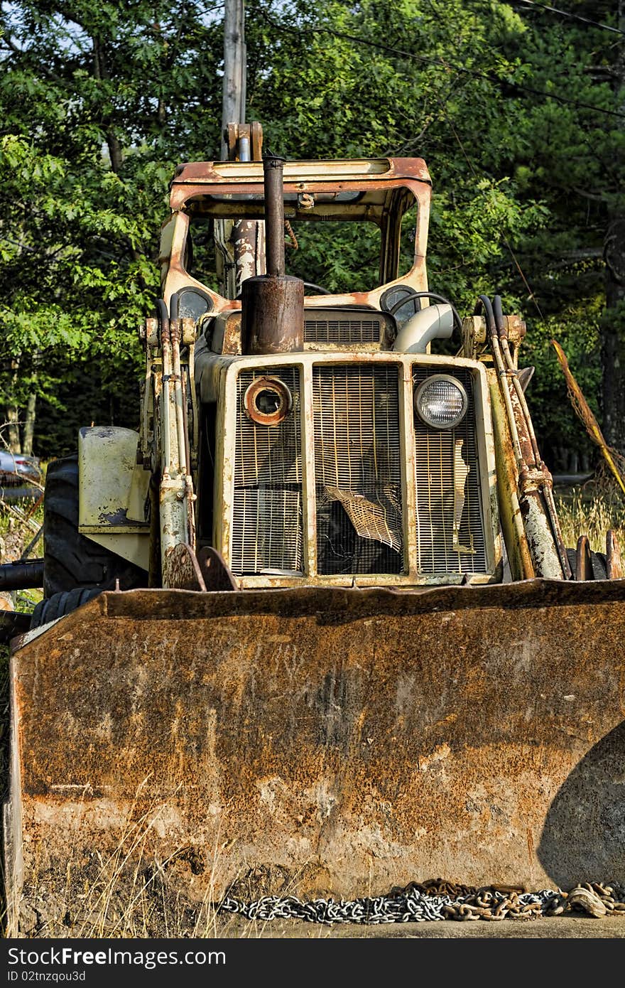 Abandon rusty tractor bulldozer in the forest