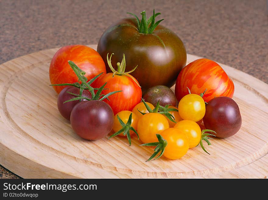 Collection of heritage tomatoes in vibrant colors of orange, brown, red and yellow. Collection of heritage tomatoes in vibrant colors of orange, brown, red and yellow