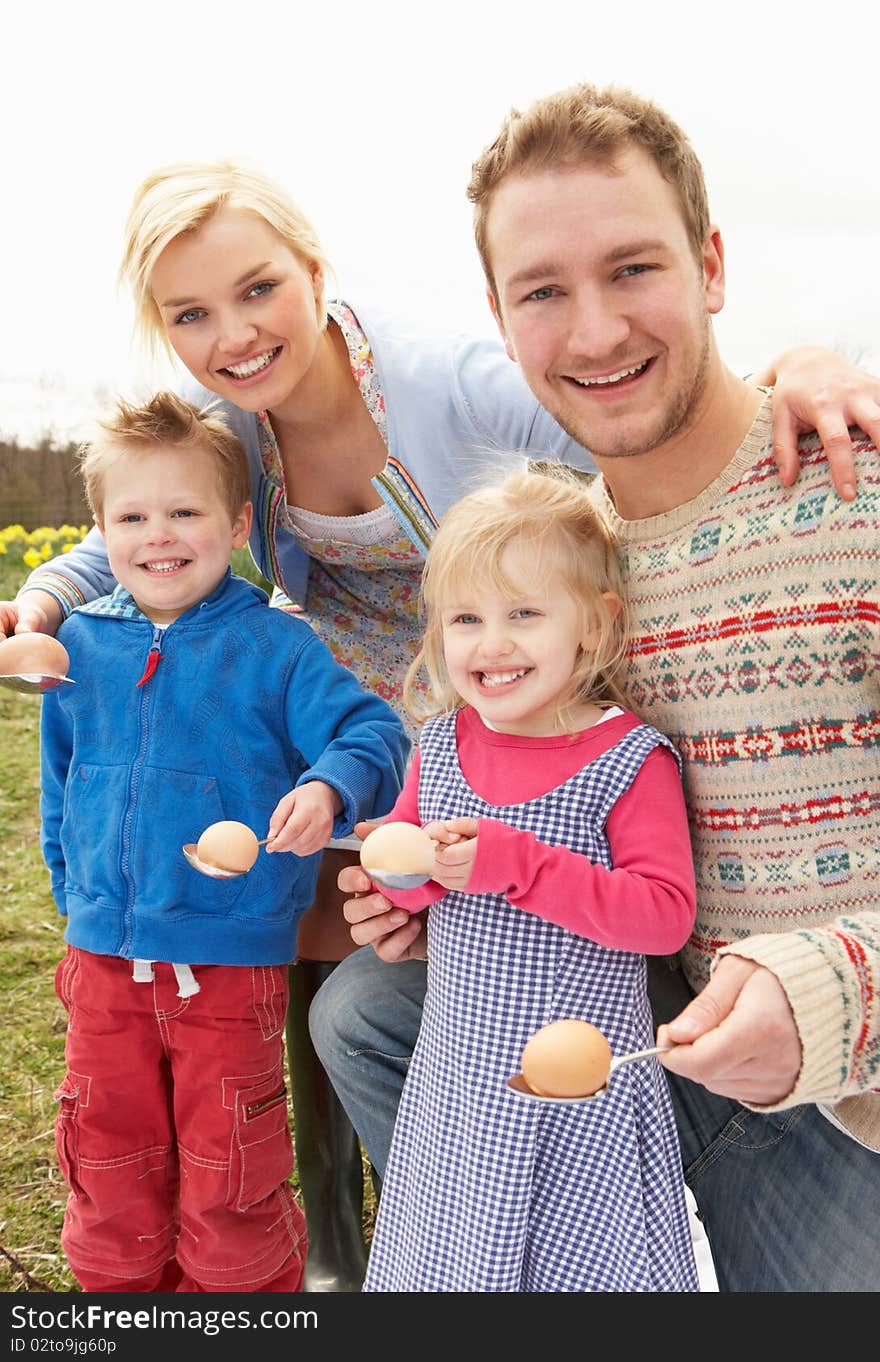 Family Having Egg And Spoon Race in the sun