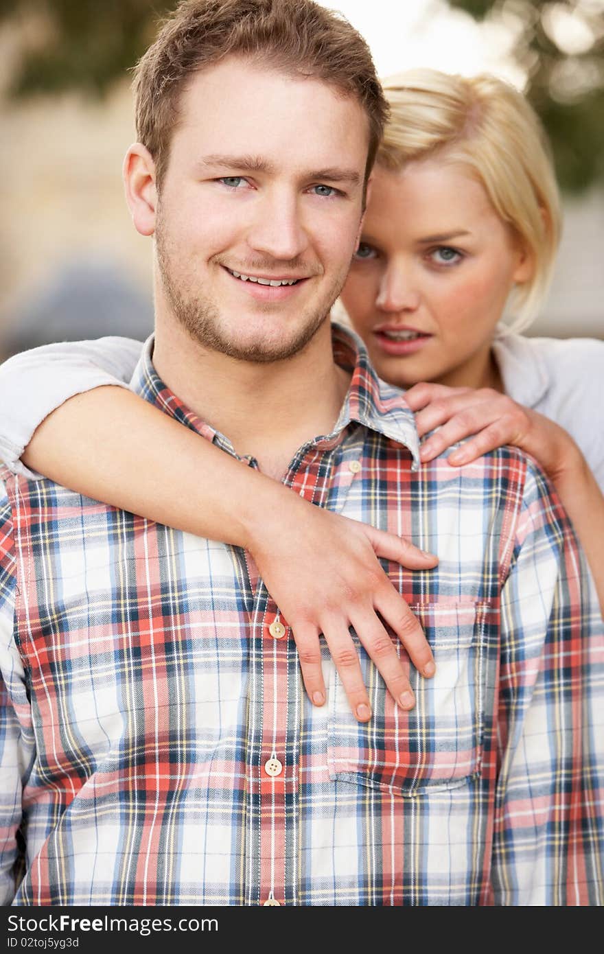 Portrait Of Romantic Young Couple Embracing