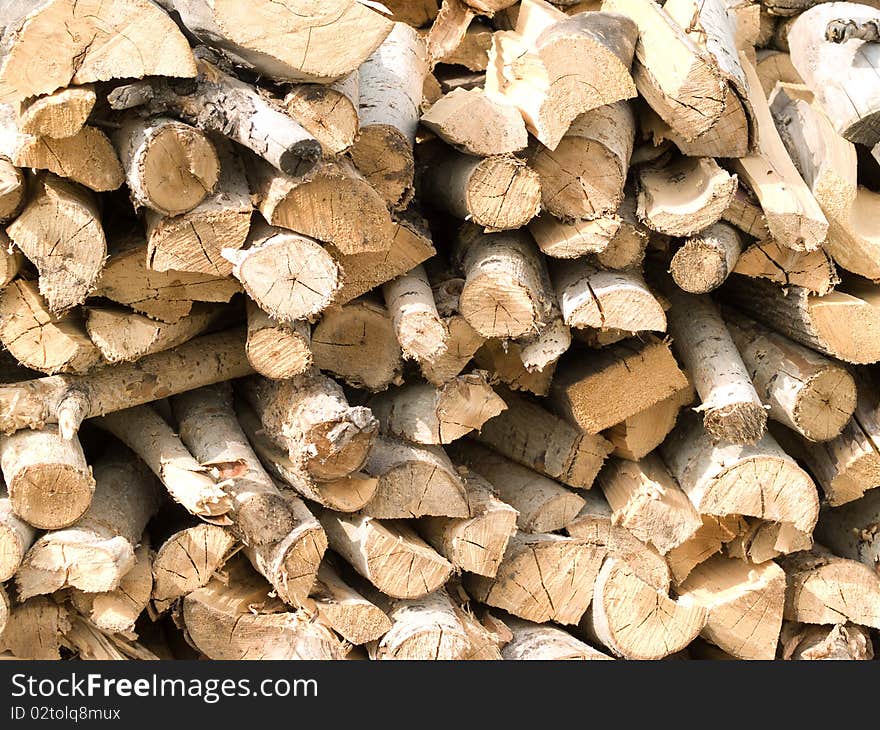 Armful of split firewood neatly stacked