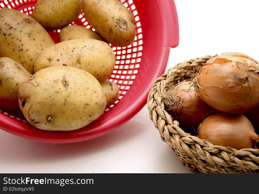 Raw potatoes in the kitchen sieve with onions. Raw potatoes in the kitchen sieve with onions